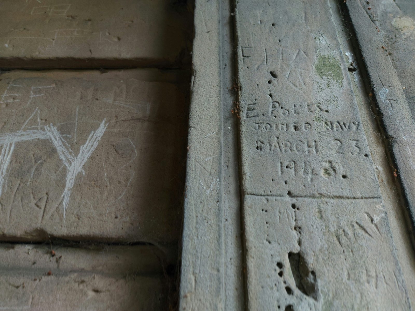 a close up of a cement block with graffiti on it